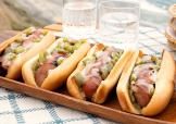 Image of Philly Cheesesteak Grilled Sausages on a tray by the beach.